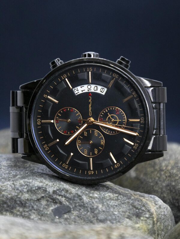 A luxurious black wristwatch showcasing precise timekeeping on natural stones.