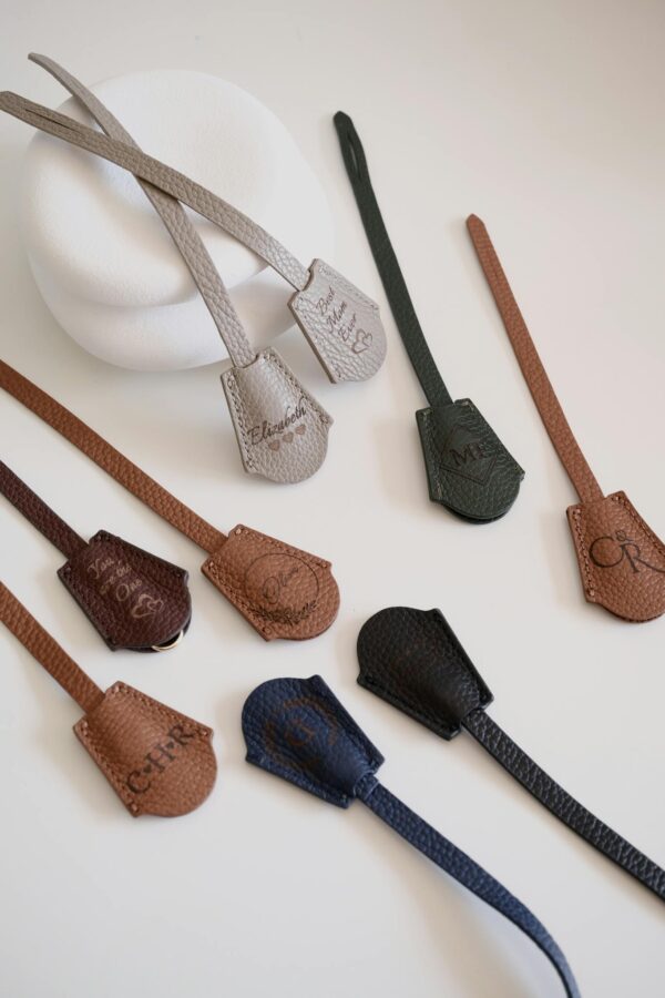 A stylish vertical array of colorful leather straps on a white background.
